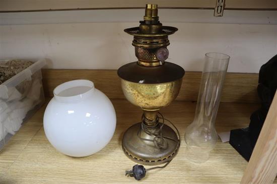 A brass oil lamp, with opaque glass shade